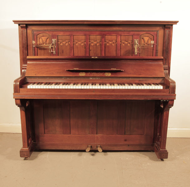 Reconditioned, Arts and Crafts style, Stichel upright piano with a polished, mahogany cabinet and cut-out front panel.  Piano has an eighty-five note keyboard and two pedals