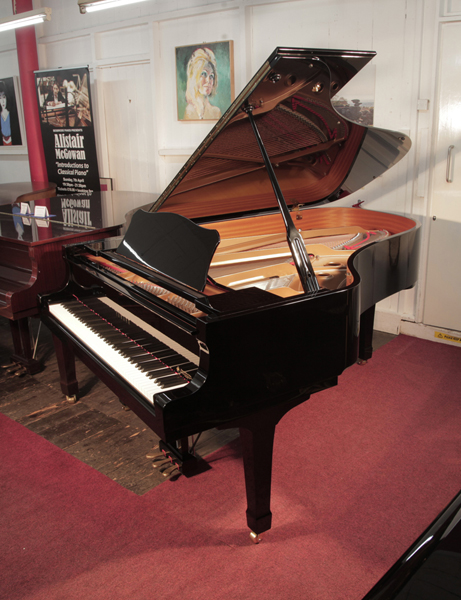 Reconditioned, 2000, Yamaha C6 grand piano for sale with a black case and spade legs. Piano has an eighty-eight note keyboard and a three-pedal lyre. 