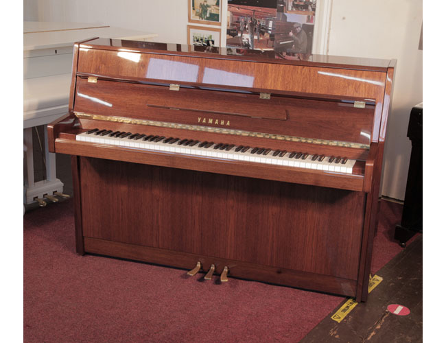 Reconditioned,  1987, Yamaha M108 Upright piano for sale with a walnut gloss case and brass fittings. Piano has an eighty-eight note keyboard and three pedals.  