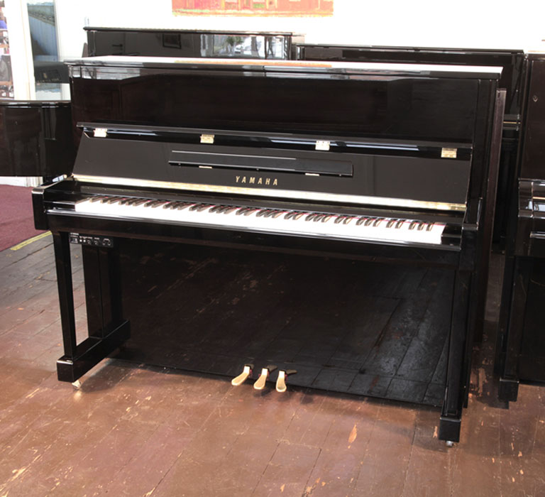 Yamaha b3e PE-Silent upright piano with a black case and fitted Silent System. Piano has an eighty-eight note keyboard and three pedals.  