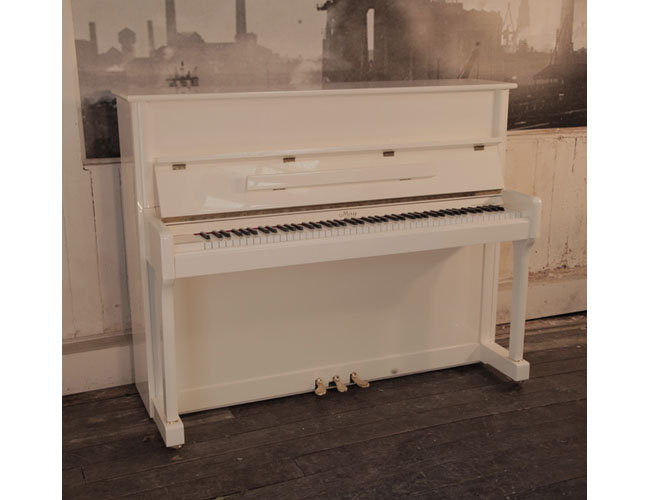 ReconditionedMay upright piano in ivory gloss with brass fittings. Piano has an eighty-eight note keyboard and three pedals.