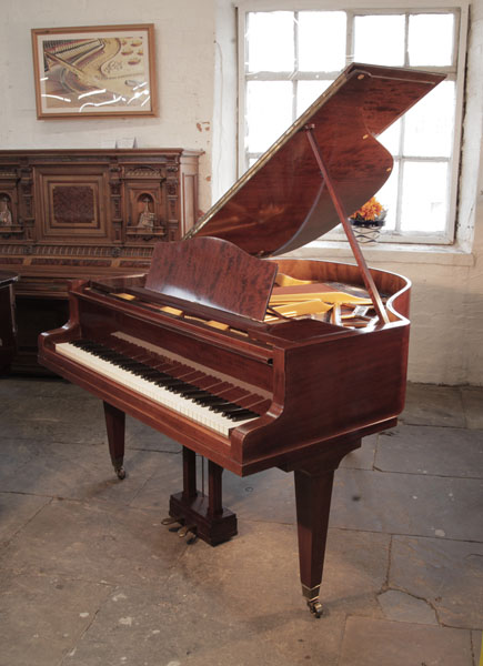 Reconditioned, 1934, Bluthner model 10 baby grand piano with a figured, mahogany case and square, tapered legs. Piano has an eighty-eight note keyboard and a two-pedal lyre