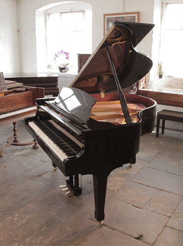 Reconditioned, Carl Steinberg baby  grand piano with a black case and brass fittings. Piano has an eighty-eight note keyboard and three-pedal lyre. A German designed, affordable baby grand made in China