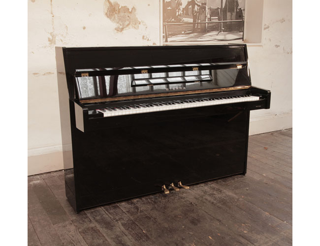 Reconditioned 1997, Eterna ER-C10 upright piano for sale in black gloss. Piano has an eighty-eight note keyboard and three pedals.