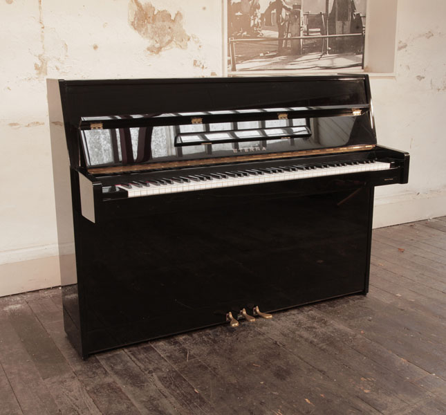A 1997, Eterna ER-C10 upright piano in black gloss. Made by Yamaha. 