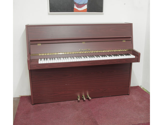 A 1977, Fazer upright piano with a mahogany case and Langer 80 action. Piano has an eighty-eight note keyboard and three pedals