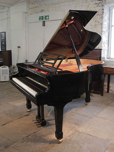 Pre-owned, Feurich model 178 Professional grand piano with a black case and brass fittings.  Piano has an eighty-eight note keyboard and a three-pedal piano lyre. 