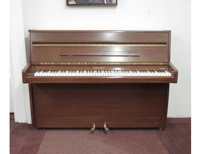 re-owned, 1970, Knight upright piano with a mahogany case. Piano has an eighty-eight note keyboard and two pedals 