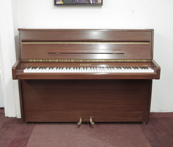 Pre-owned, 1970, Knight upright piano with a mahogany case. Piano has an eighty-eight note keyboard and two pedals.