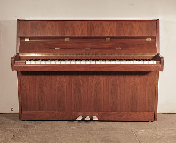 Ottostein SU-108P upright piano with a crown-cut walnut case. Piano has an eighty-eight note keyboard and three pedals. 