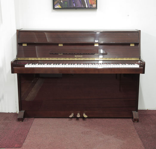 Royale VS-41  upright piano with a mahogany gloss case. Piano has an eighty-eight note keyboard and three pedals. 