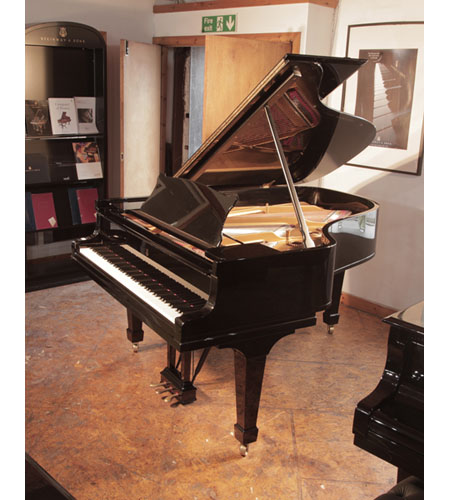 A 1916, Steinway Model A grand piano with a with a black case and spade legs. Piano has an eighty-eight note keyboard and a two-pedal lyre.