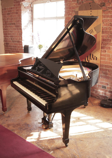 A 1925, Steinway Model S baby  grand piano for sale with a black  case and spade legs. Piano has an eighty-eight note keyboard and a two-pedal lyre.