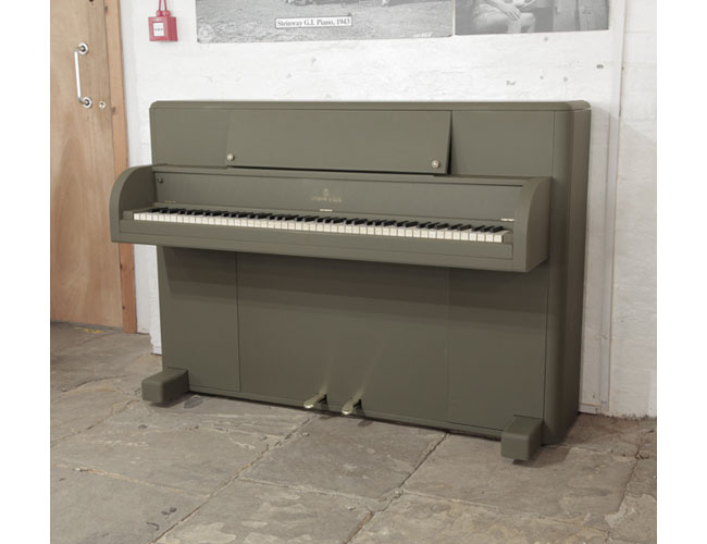 A 1944, Steinway Victory Vertical upright piano with an olive drab case.  These uprights were airdropped onto battlefields via parachutes during WWII for the entertainment of G.I. American troops