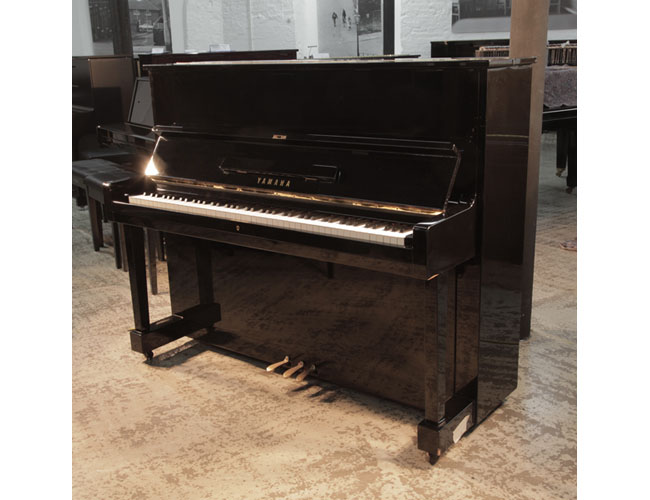 Reconditioned, 1994, Yamaha U1 upright piano with a black case and polyester finish. Piano has an eighty-eight note keyboard and three pedals.