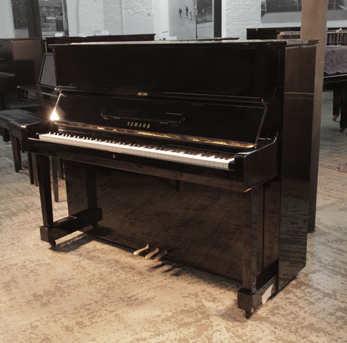 Reconditioned, 1994, Yamaha U1 upright piano with a black case and polyester finish. Piano has an eighty-eight note keyboard and three pedals. 