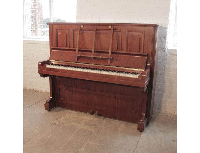Reconditioned, 1923, Bechstein model 8 upright piano with a rosewood case and brass fittings. Piano has an eighty-eight note keyboard and two pedals. 