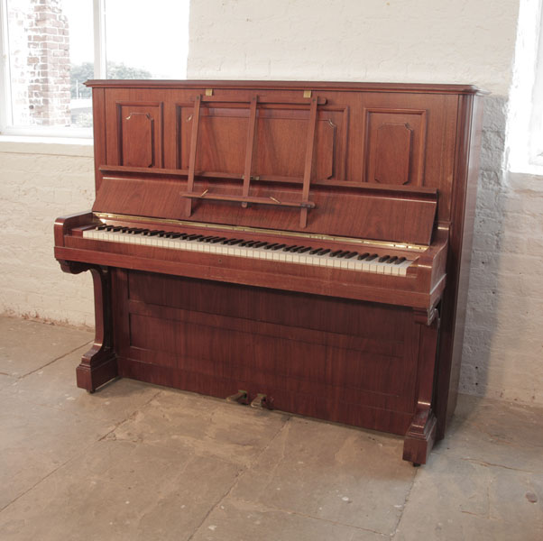 Reconditioned, 1923, Bechstein  model 8  upright piano with a rosewood case and brass fittings. Piano has an eighty-eight note keyboard and two pedals. 