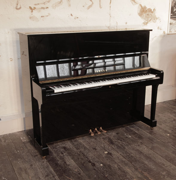 Reconditioned, 1994, Yamaha U1 upright piano for sale with a black case and brass fittings. Piano has an eighty-eight note keyboard and three pedals.  